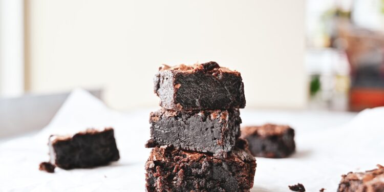 Stack of homemade brownies on parchment paper
