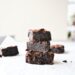 Stack of homemade brownies on parchment paper